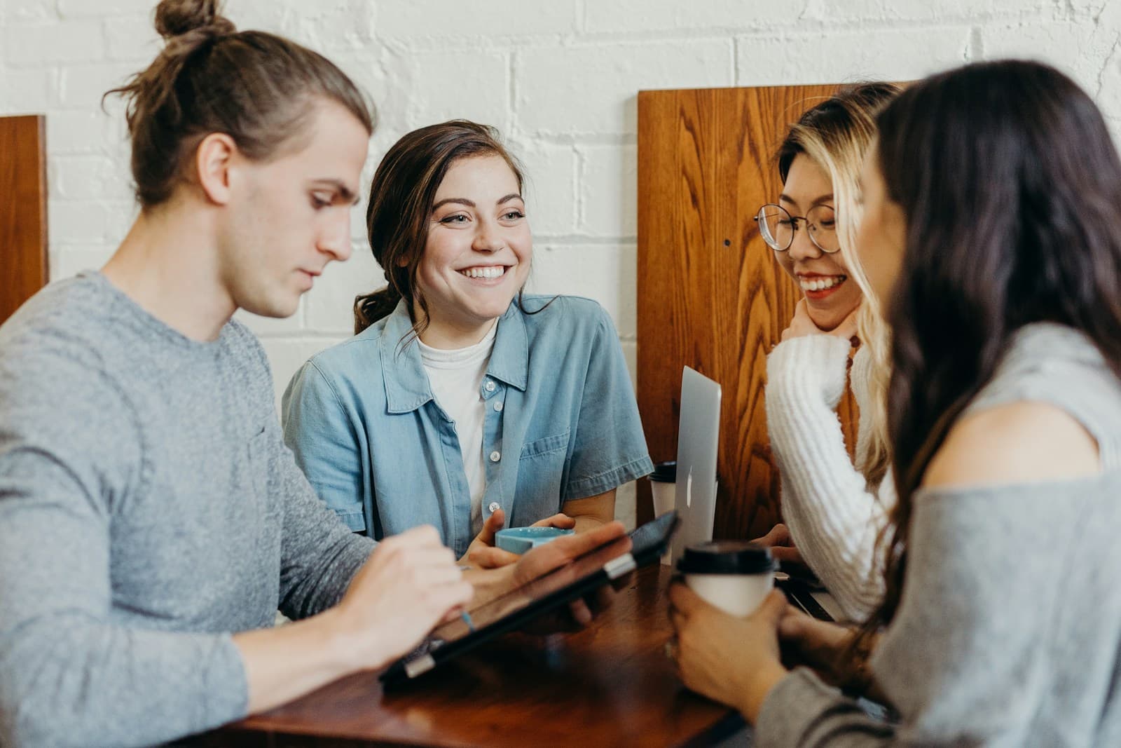 Two women laughing together over coffee